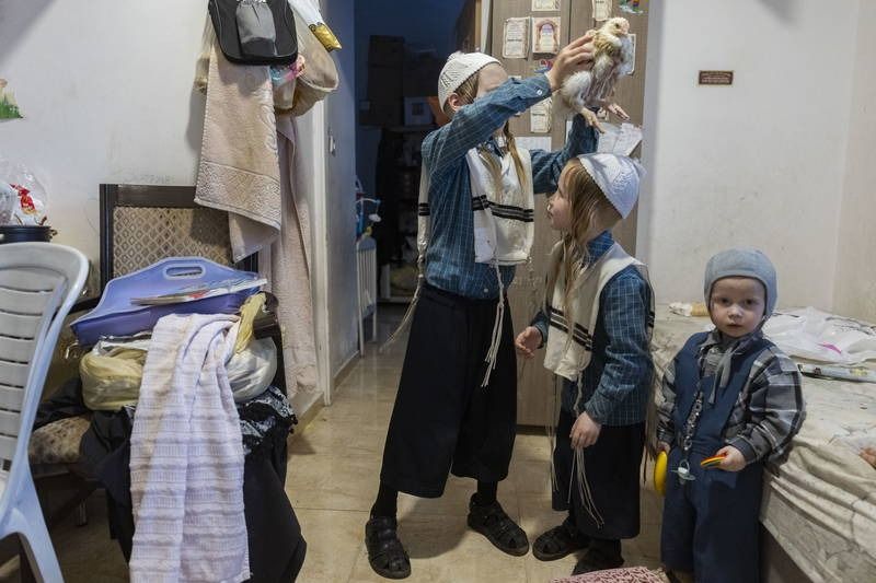 That's how we do it: In Mea Shearim streets, even small children perform kapparot with chickens